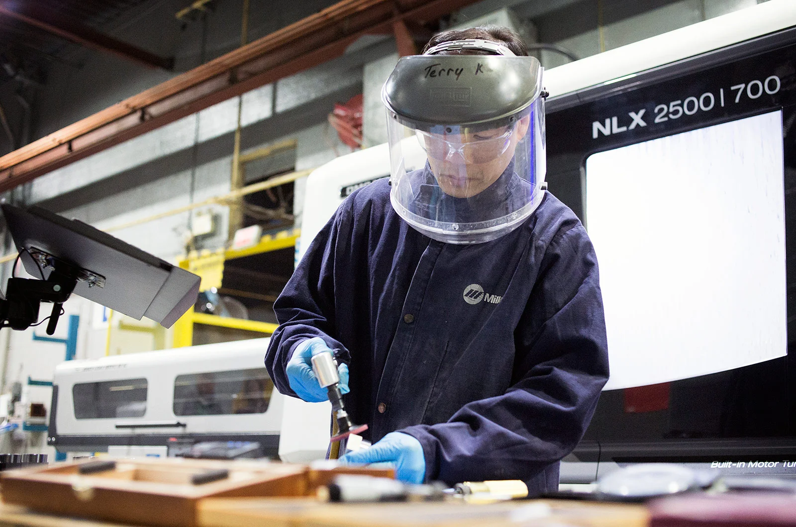DEW employee working in precision manufacturing