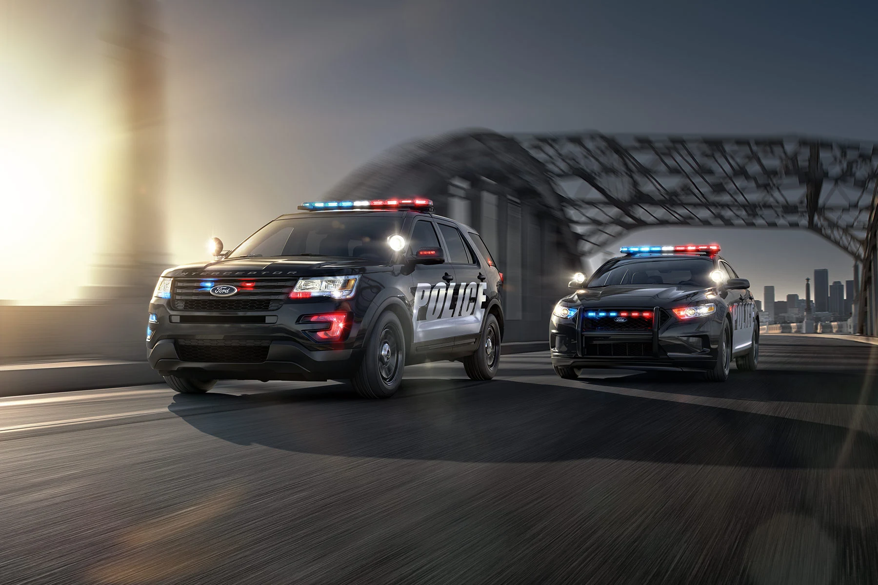 Police utility vehicle and sedan on a roadway